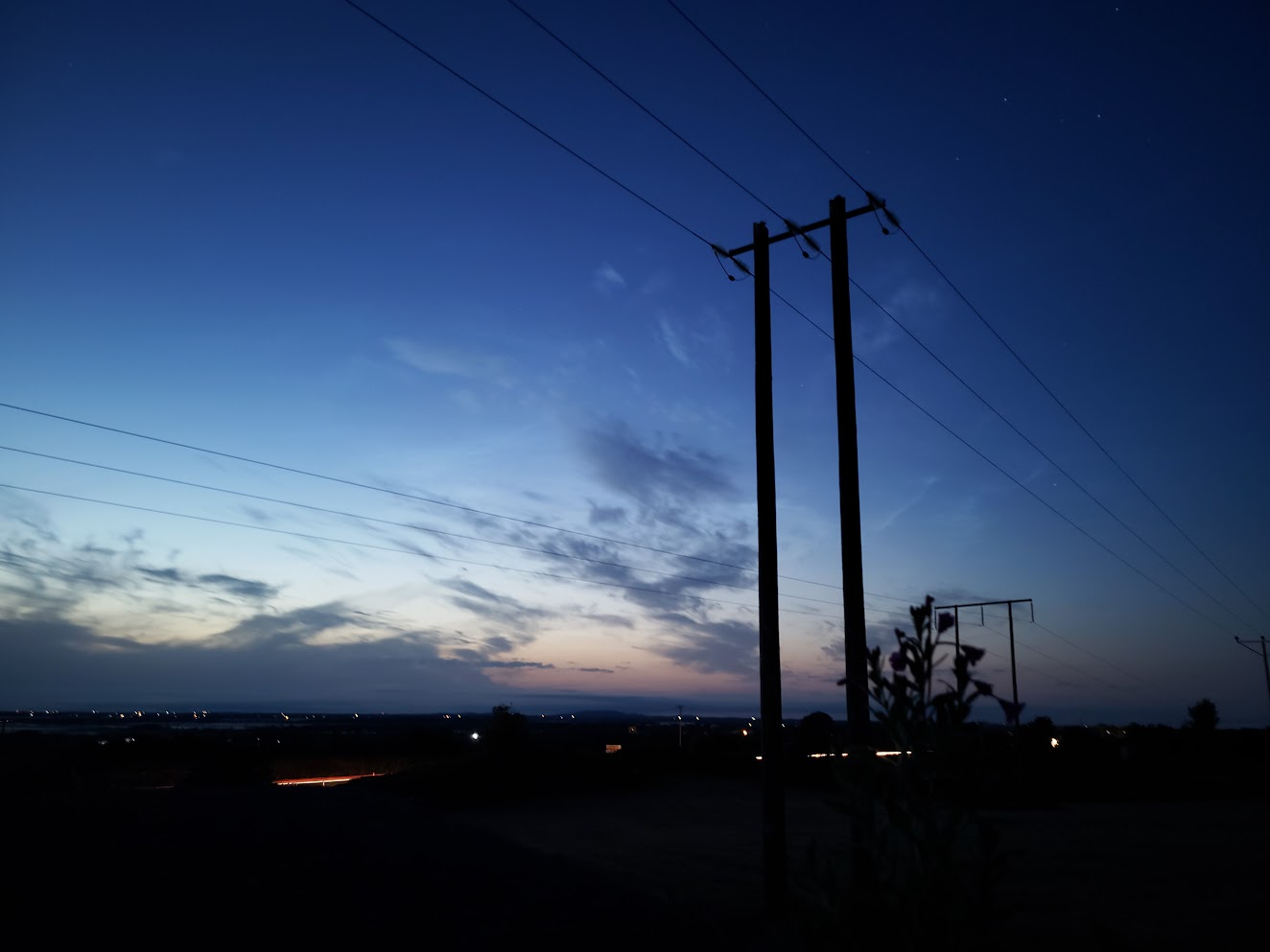 Power lines silhouetted against a blue Galway evening sky.